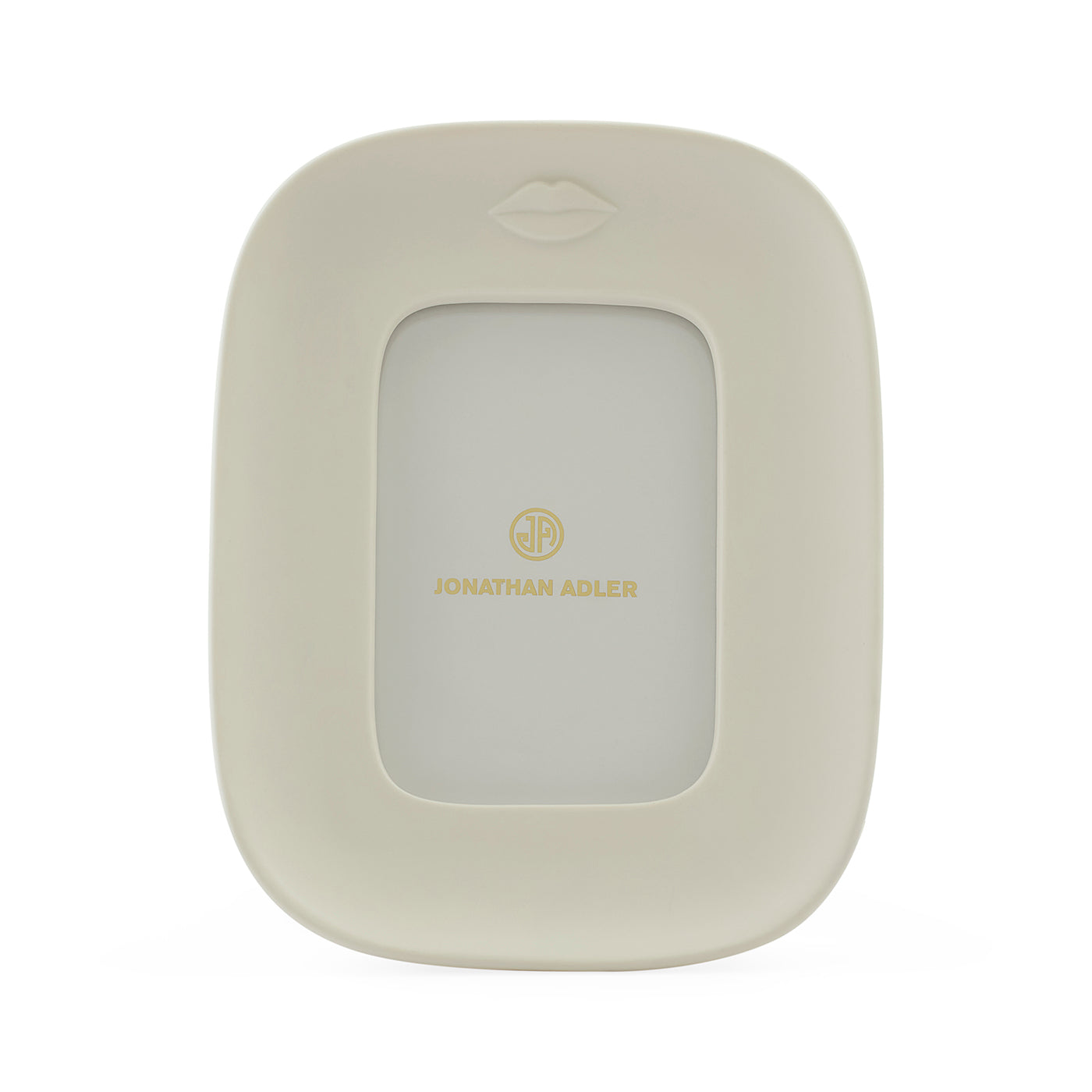 Jonathan Adler picture frame in a warm cream color with a gold logo and a subtle lips icon at the top, shown on a clean white background.