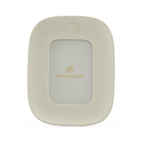 Jonathan Adler picture frame in a warm cream color with a gold logo and a subtle lips icon at the top, shown on a clean white background.