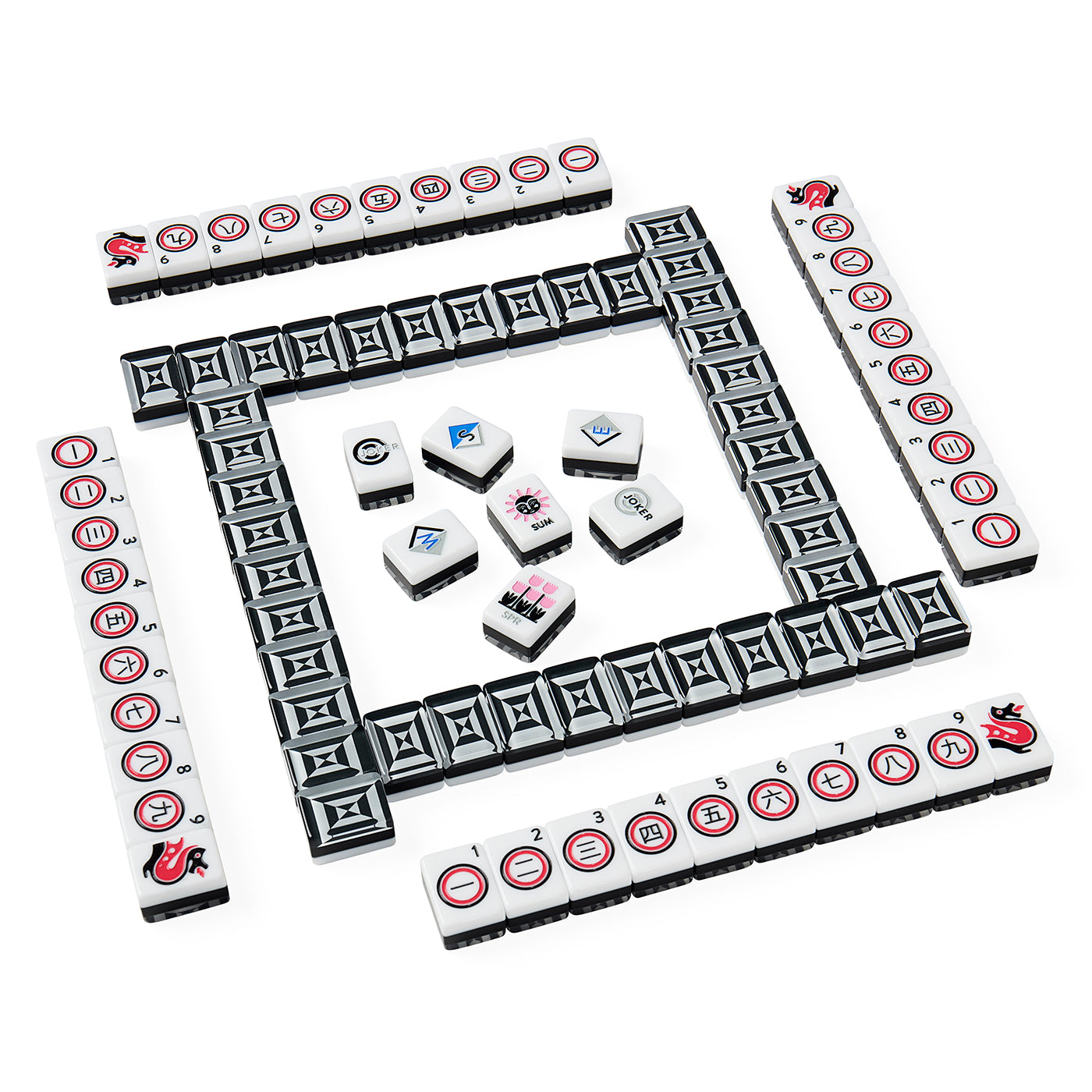 A set of Mahjong tiles arranged on a plain white background, with a rectangular outer wall and several inner tiles fanned out in the center. The tiles are predominantly white with black geometric patterns and red circular markings, plus a few smaller tiles showing blue, pink, and gray designs.