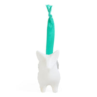 A white ceramic dog-shaped ornament with a bright teal ribbon loop at the top, shown against a plain white background.