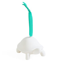 A white turtle-shaped hanging ornament with a bright teal hanging ribbon, shown against a plain white background.
