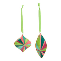 Two hanging ornament shapes with long lime green ribbons, featuring a multicolor geometric fan pattern in green, pink, teal, and light blue outlined with gold trim, on a white background.