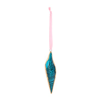 A seashell-shaped ornament with a turquoise blue and teal patterned center, a gold-colored border, and a pink hanging ribbon at the top, shown against a plain white background.