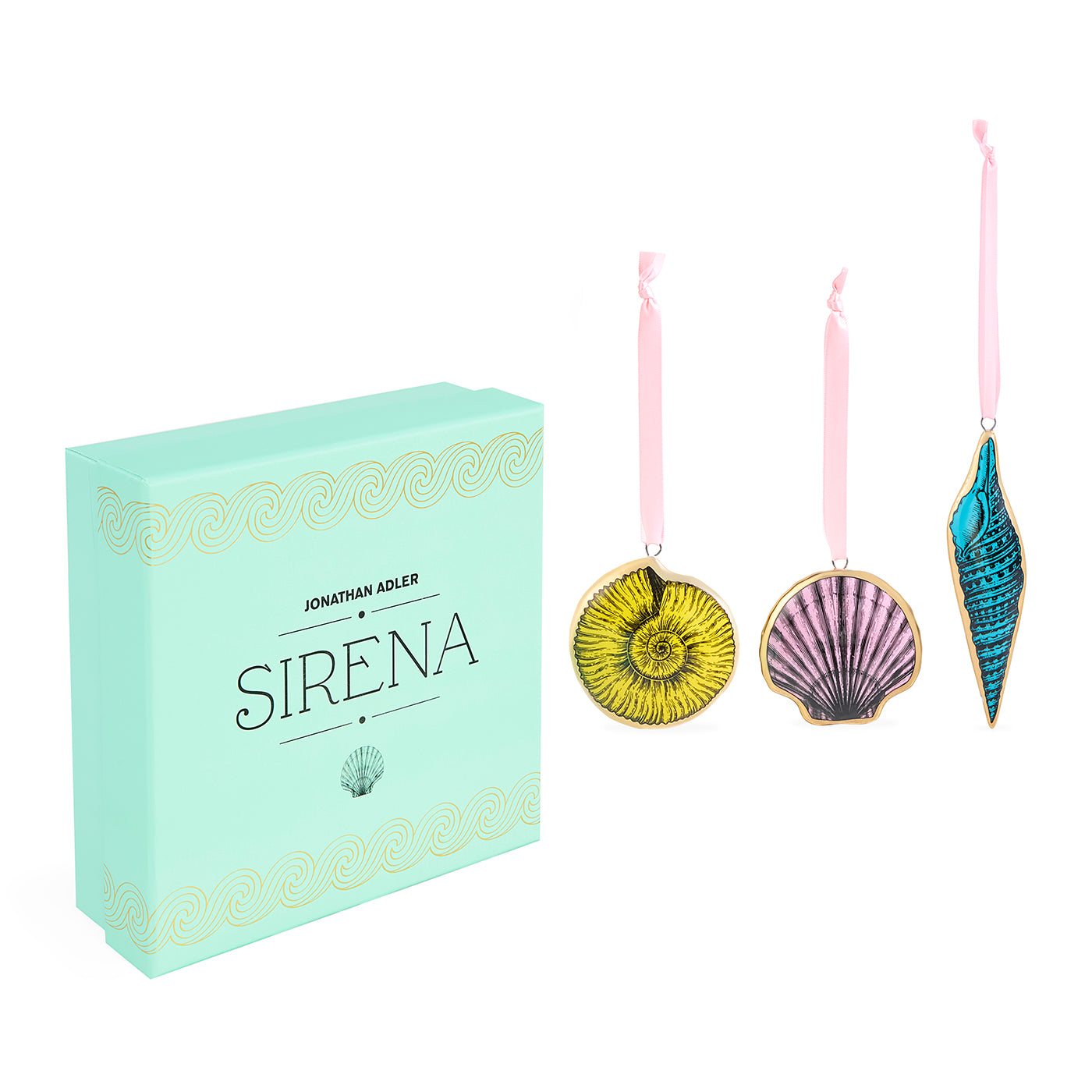 Jonathan Adler Sirena ornament set featuring a mint green gift box and three hanging seashell ornaments in yellow, pink, and blue with gold trim on a white background.