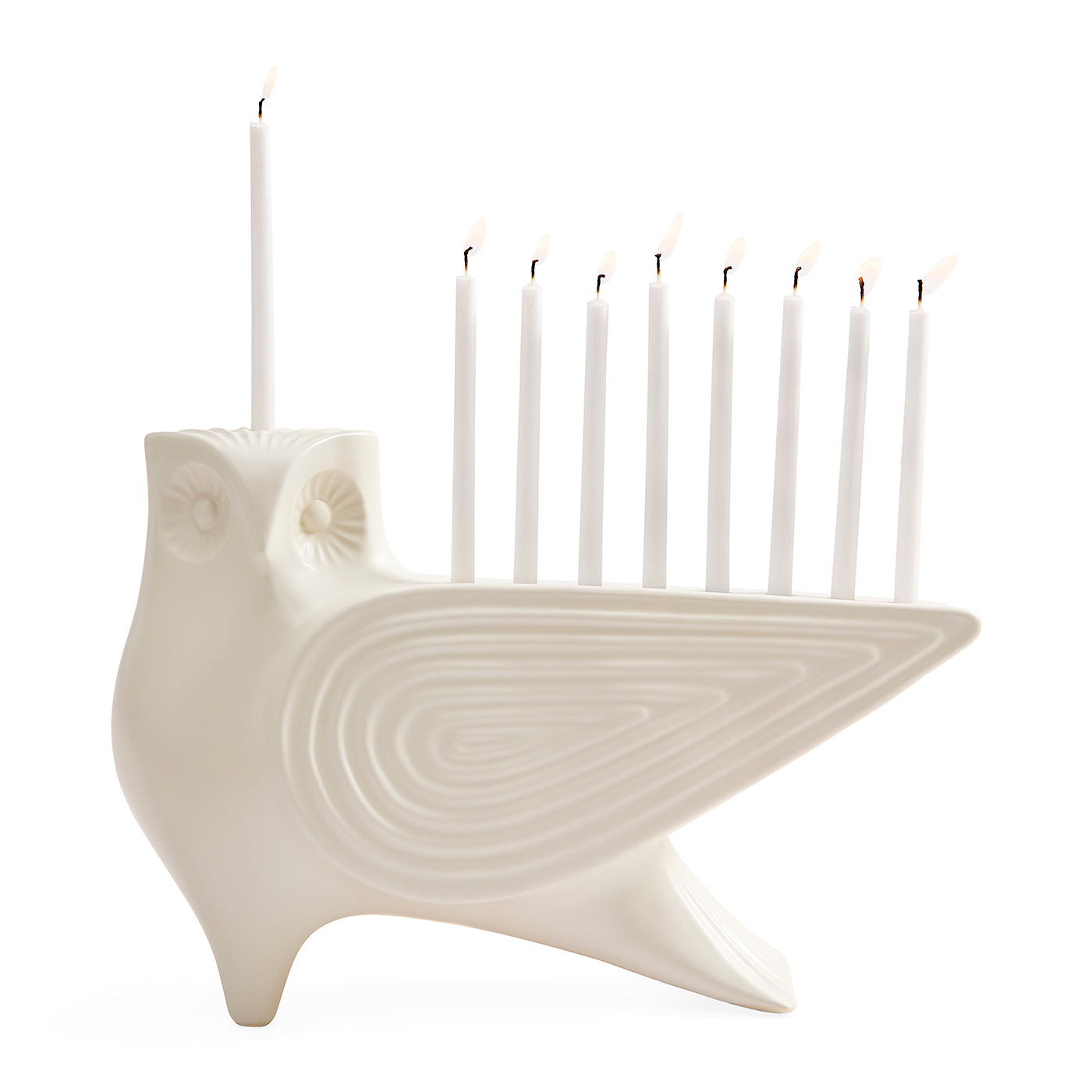 An off-white ceramic owl-shaped Hanukkah menorah holding nine lit white candles, set against a solid white background.