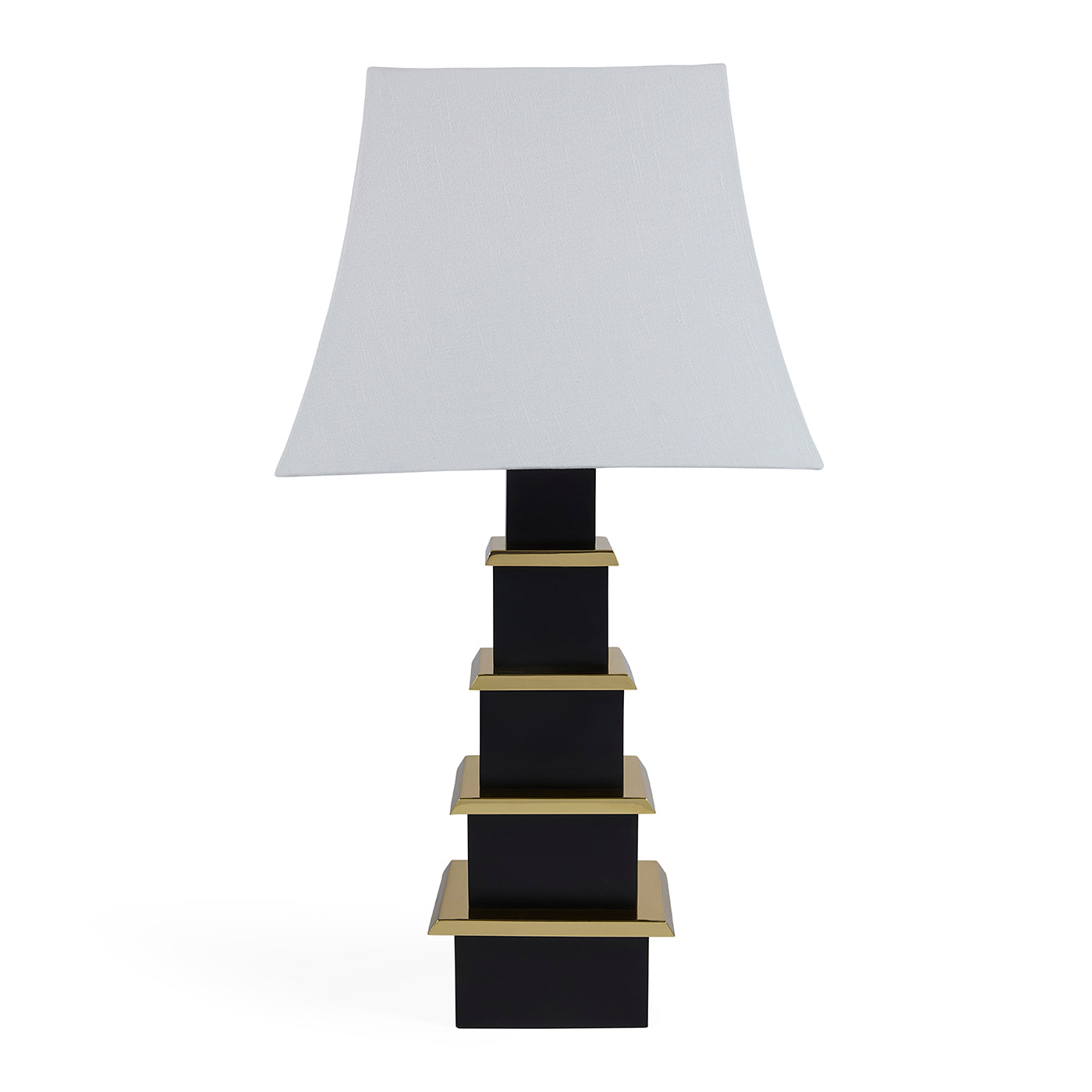Table lamp with a white shade and black base with gold accents on a white background