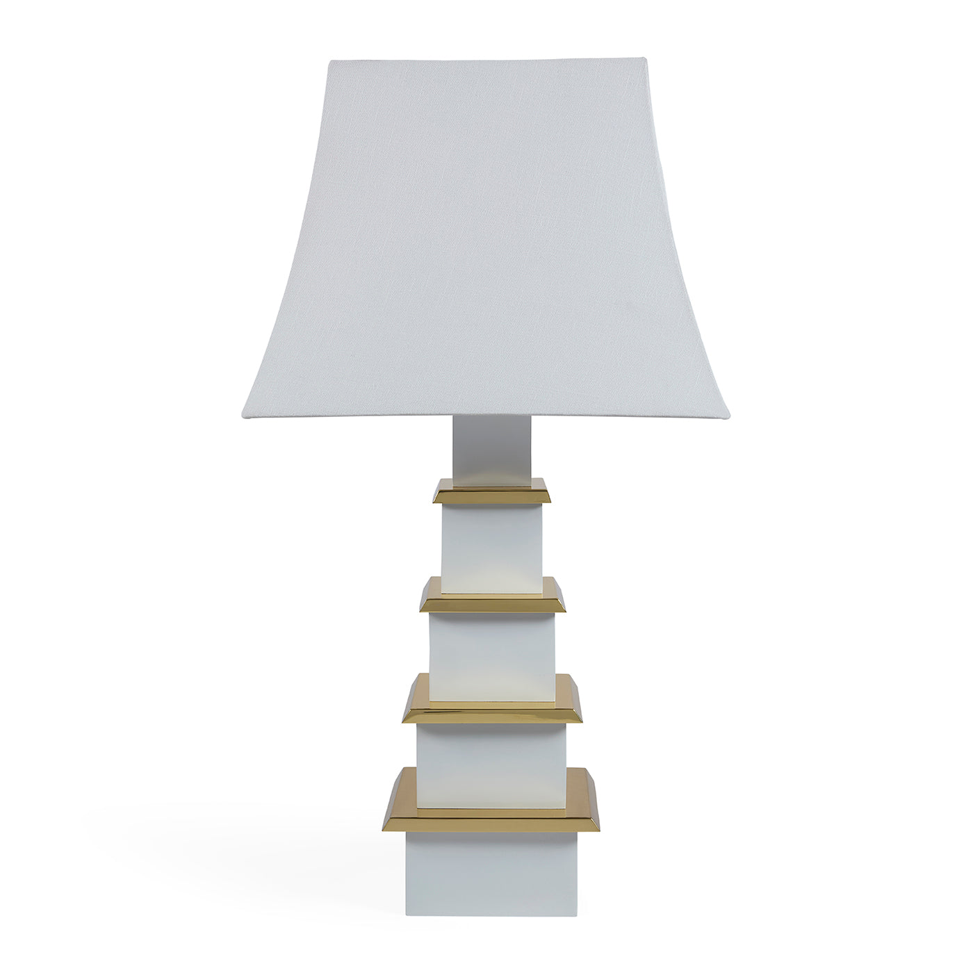 Table lamp with a white shade and gold accents on a white background