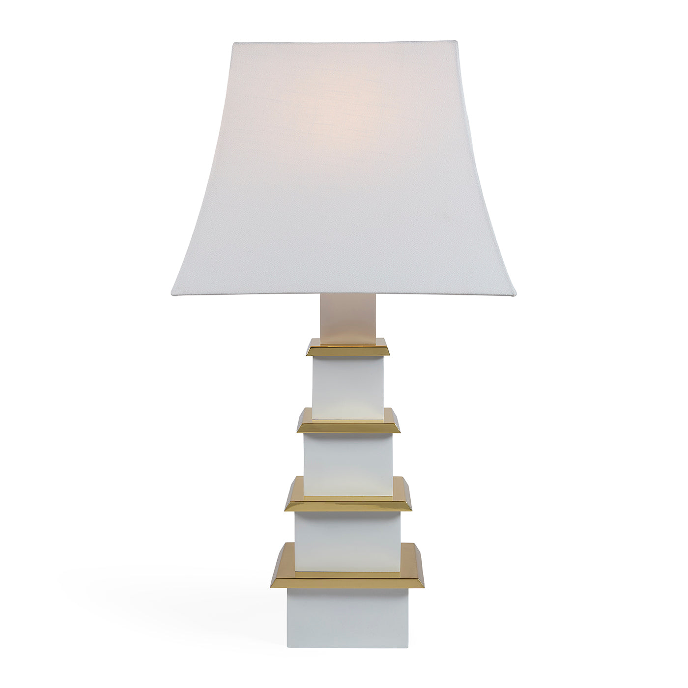 Table lamp with a white shade and gold accents on a white background