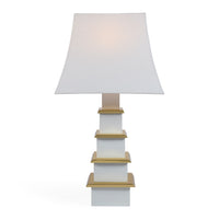 Table lamp with a white shade and gold accents on a white background