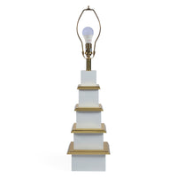 Decorative lamp with white and gold base on a white background