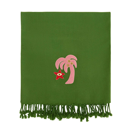 Green blanket with pink palm tree and red star design on a white background