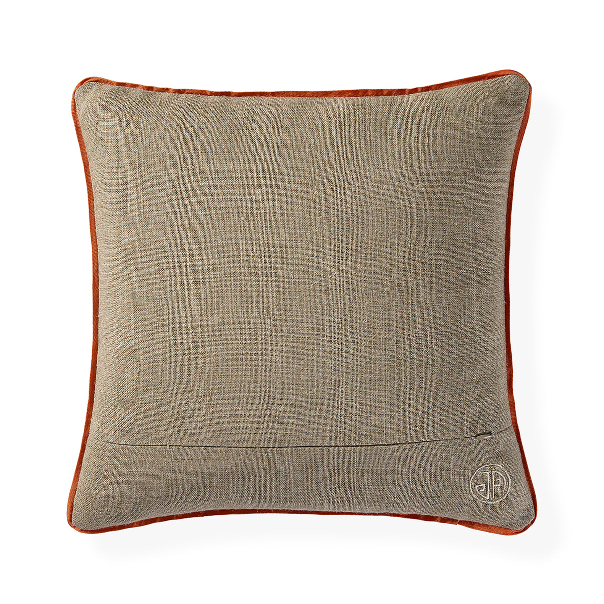 A square decorative throw pillow featuring a textured beige linen-like fabric body and a contrasting rust-orange velvet piped border, with a small circular embroidered monogram logo in the bottom right corner.