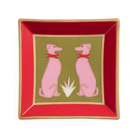 A square decorative plate with a red border, gold trim, and a central olive-green panel featuring two pink dogs wearing red bows, set against a plain white background.
