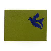 Green leather patch with a blue bird design on a white background