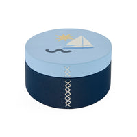 Round decorative box with nautical design elements on a white background