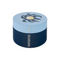 Round blue and navy box with decorative patterns on a white background