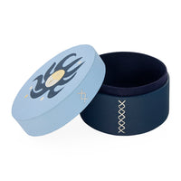 Navy blue container with lid featuring a design on a white background