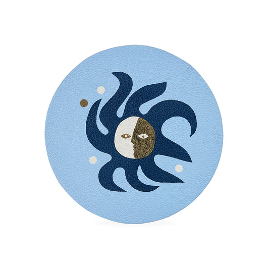 Decorative coaster with sun and moon design on a light blue background