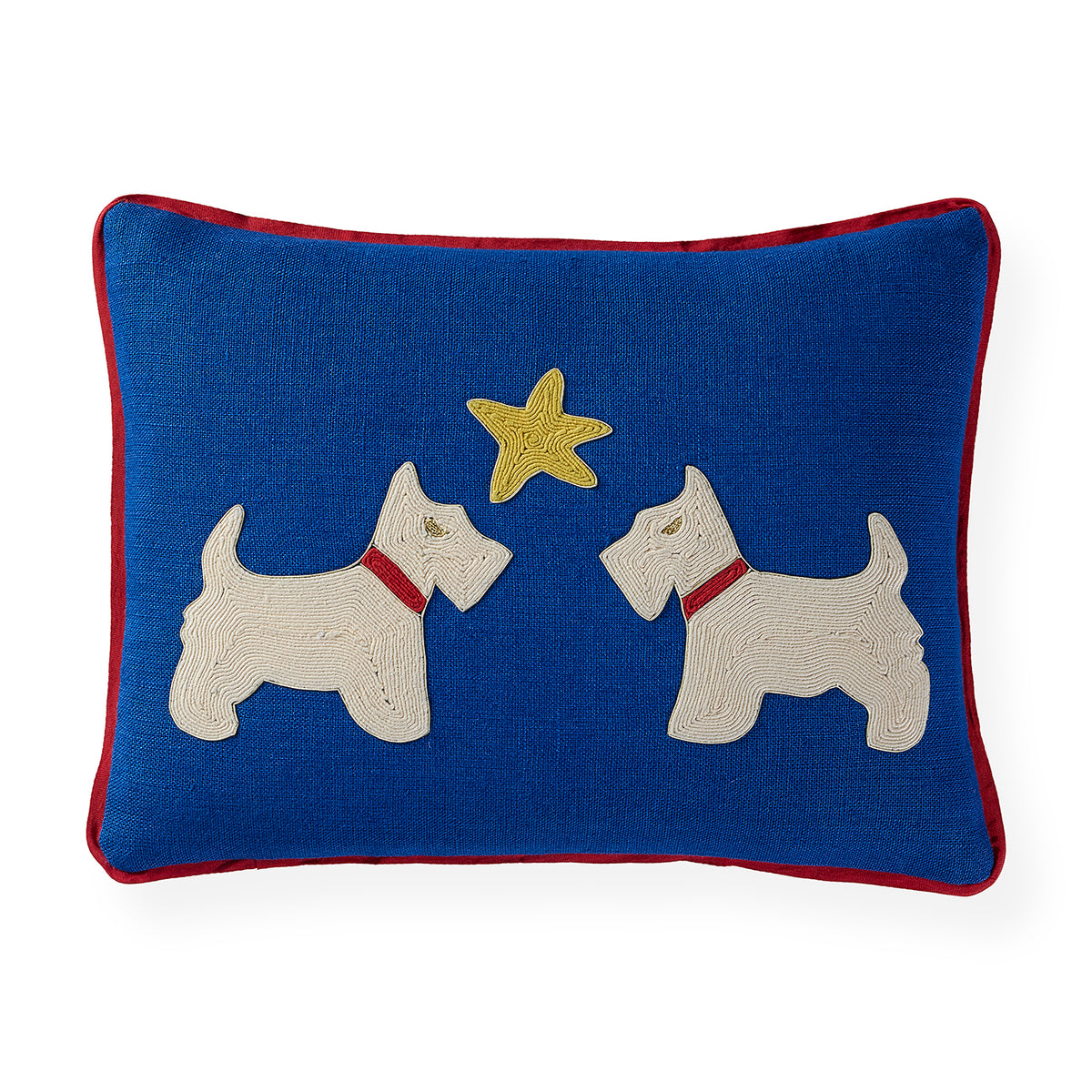A square blue throw pillow with a red border, featuring two white Scottie dogs facing each other with a yellow star embroidered between them.
