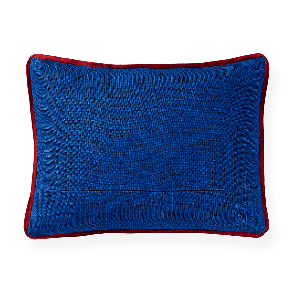 A rectangular blue lumbar pillow with a contrasting red border, featuring a subtle embroidered monogram logo in the bottom right corner, set against a plain white background.