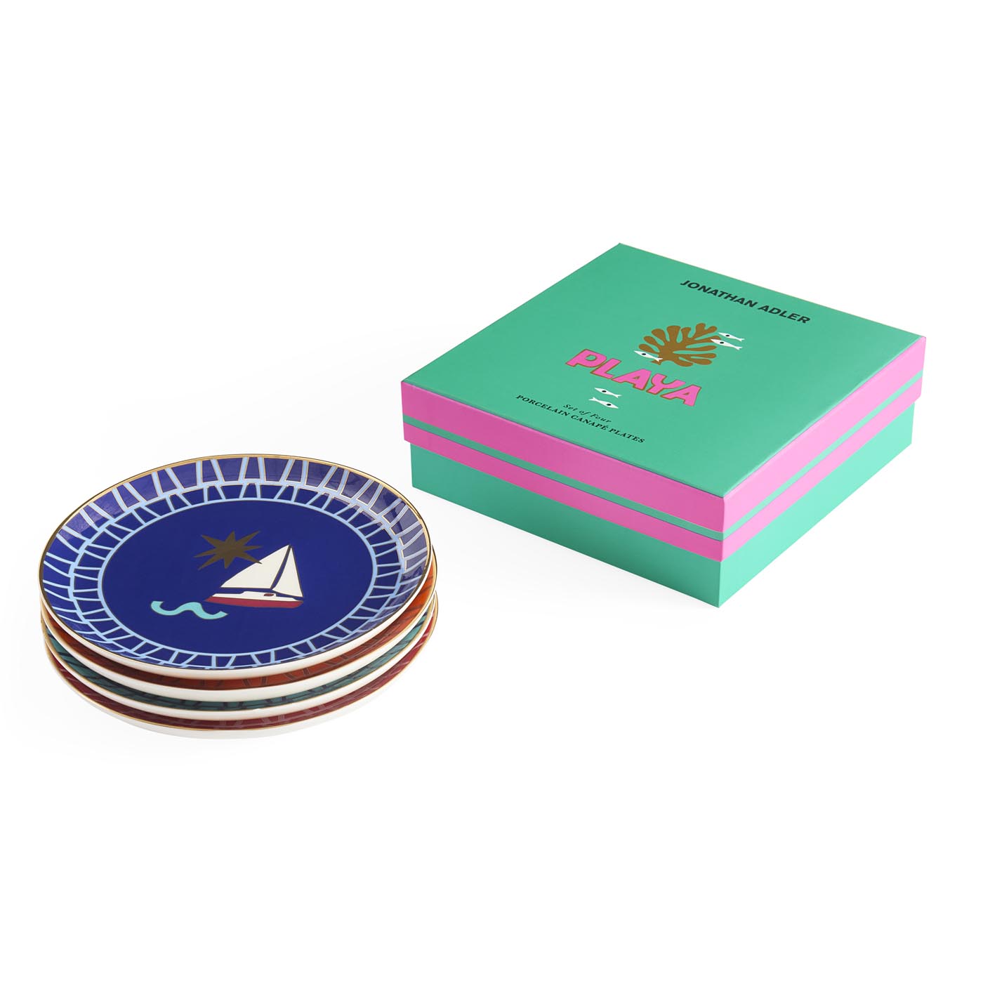 Set of decorative plates with a Jonathan Adler branded box on a white background
