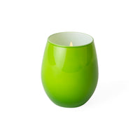 A bright green ceramic candle holder with a lit candle inside, set against a plain white background.