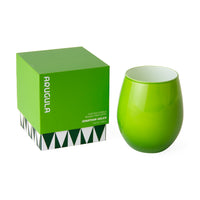 A bright green ceramic stemless wine glass next to its matching green square box with white text and a geometric patterned base, on a white background.