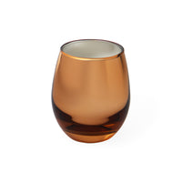 An amber-colored translucent stemless glass tumbler on a solid white background.