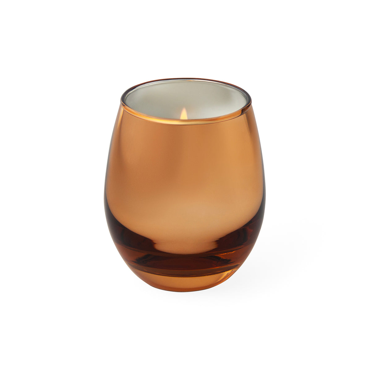 An amber glass candle holder with a lit candle inside, set against a plain white background.