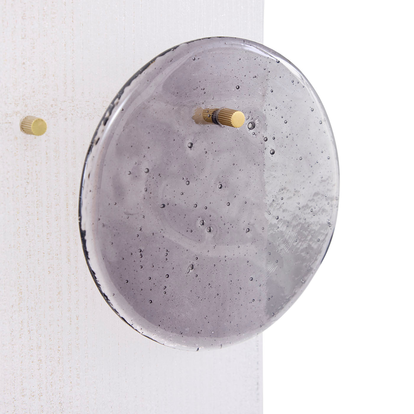 Round concrete wall clock with gold accents on a white background