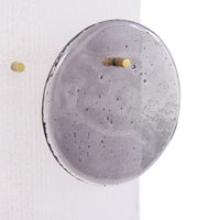 Round concrete wall clock with gold accents on a white background