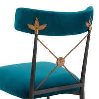 Teal chair with decorative backrest and seat on a white background