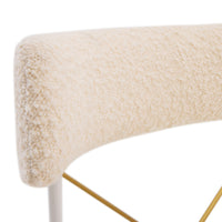 Close-up of a textured beige surface with a white base and gold legs on a white background
