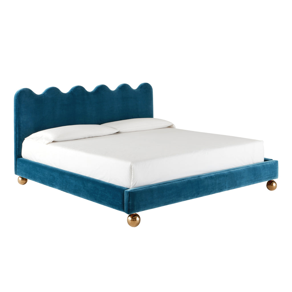 Blue velvet king bed with scalloped headboard and gold ball feet
