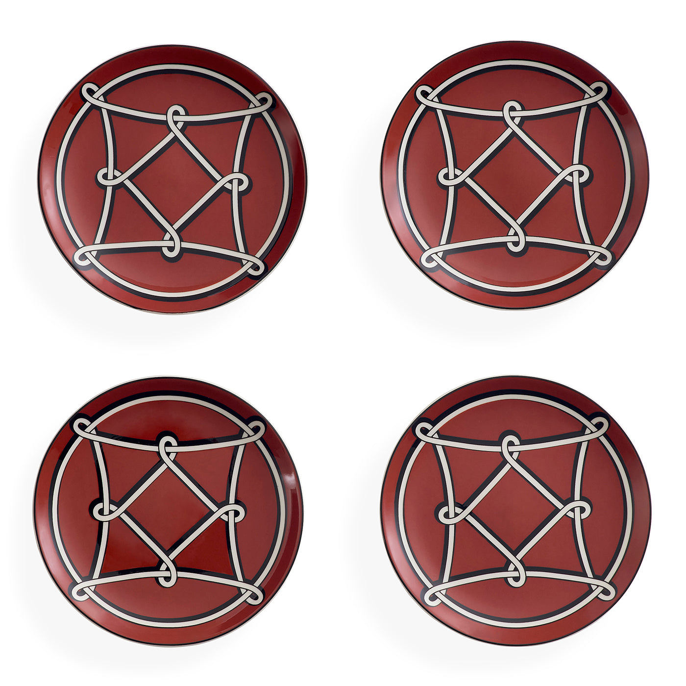Four round red coasters arranged in a 2x2 grid on a white background, each featuring a white geometric rope-knot design over a circular motif.