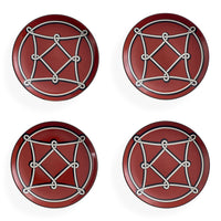 Four round red coasters arranged in a 2x2 grid on a white background, each featuring a white geometric rope-knot design over a circular motif.