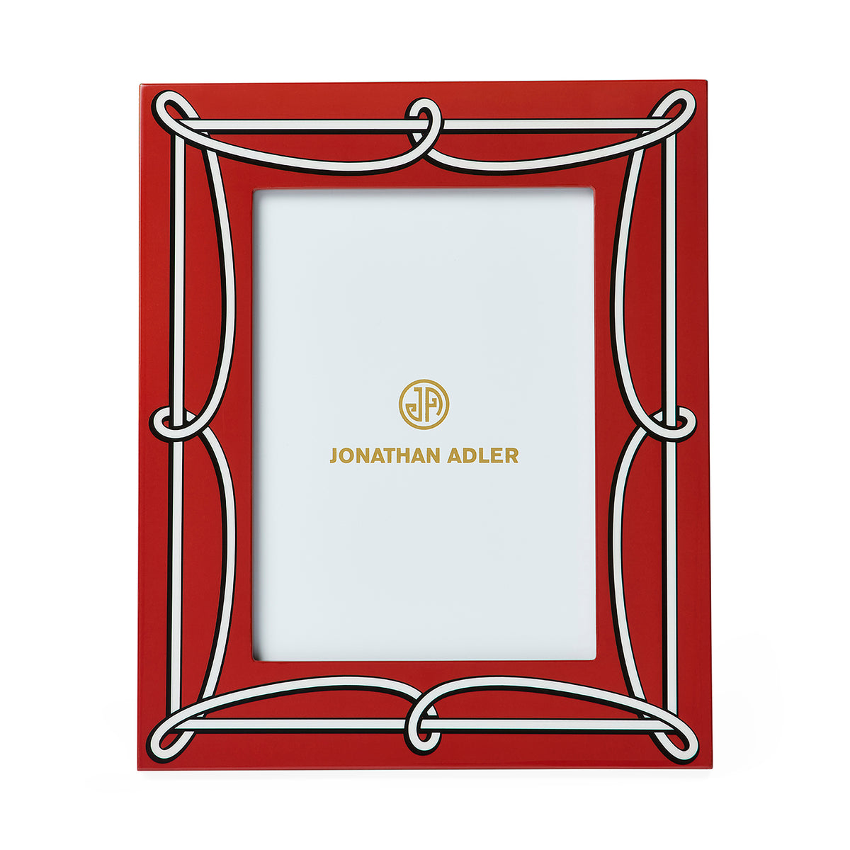 A red rectangular picture frame with an ornate white decorative border and gold Jonathan Adler branding printed in the center of the insert.