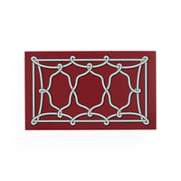 A rectangular red mat featuring a white interlocking knot-like geometric pattern, shown on a plain white background.