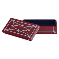 A rectangular decorative box in deep red with a white ornamental line pattern on the lid, shown open to reveal a black interior, on a plain white background.