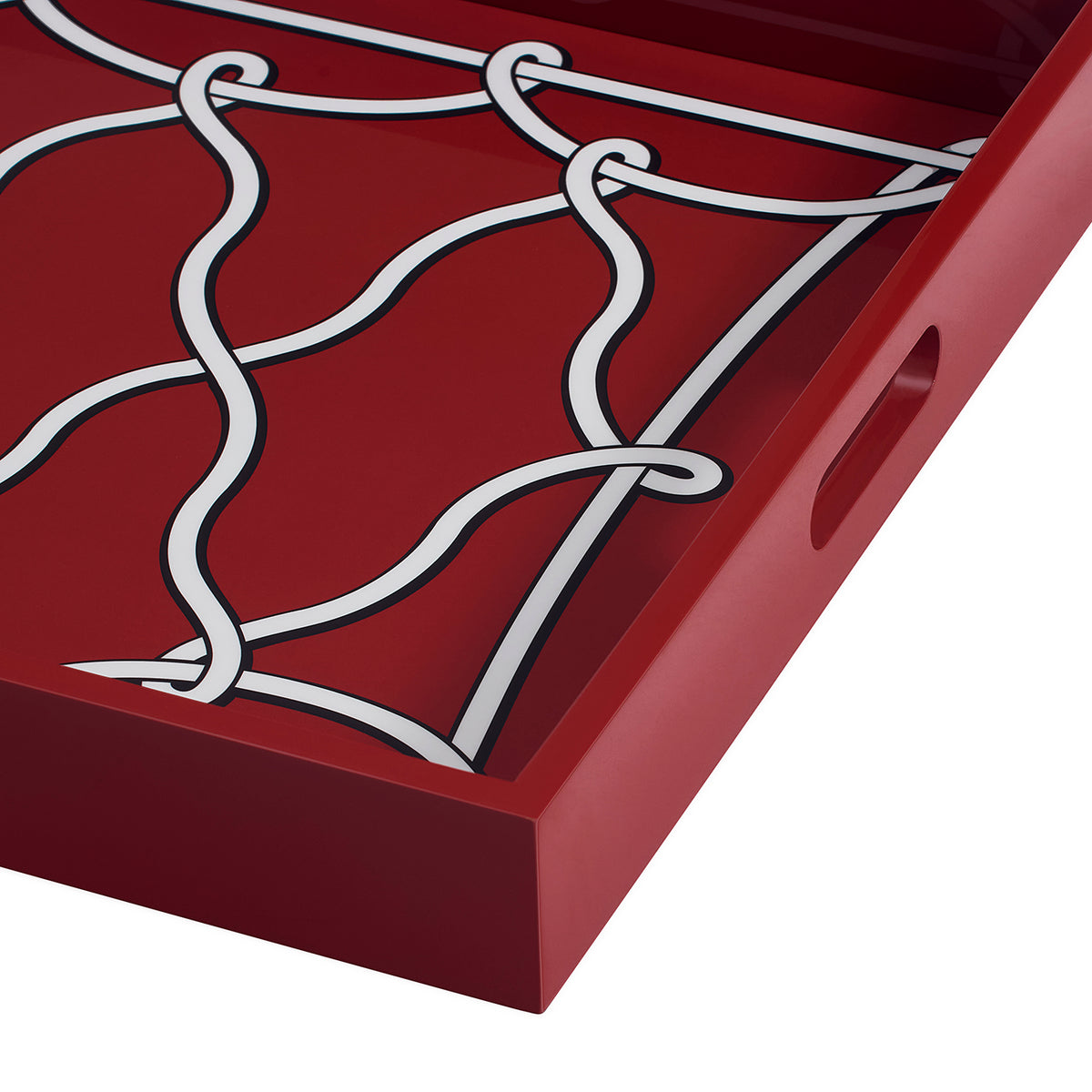 Close-up of a red rectangular tray with a white wavy lattice pattern printed across the interior and a side handle cutout, shown on a white background.
