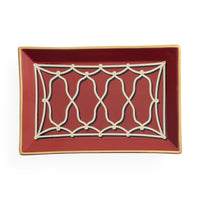 A rectangular ceramic serving tray with a deep red interior, featuring a cream-colored geometric lattice pattern in the center and a thin gold rim.