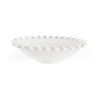 White ceramic bowl with textured rim on a white background