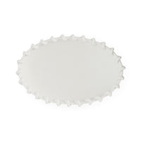 White scalloped-edge plate on a white background