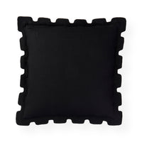 A square black throw pillow with a decorative scalloped or wavy piped border, shown from a top-down view on a solid white background.