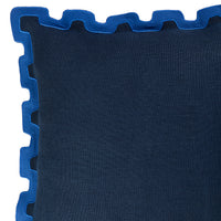 Close-up of a dark blue textured throw pillow with a contrasting bright blue scalloped edge trim, shown against a white background.