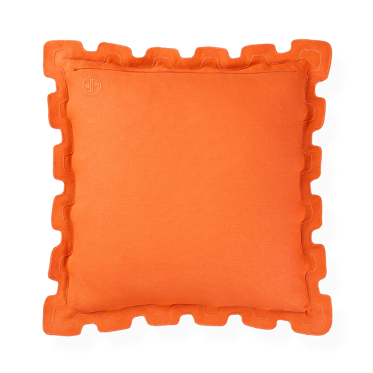 A square orange throw pillow with a decorative wavy ruffled border, shown flat against a solid white background. A small circular embroidered logo is visible in the top-left corner.