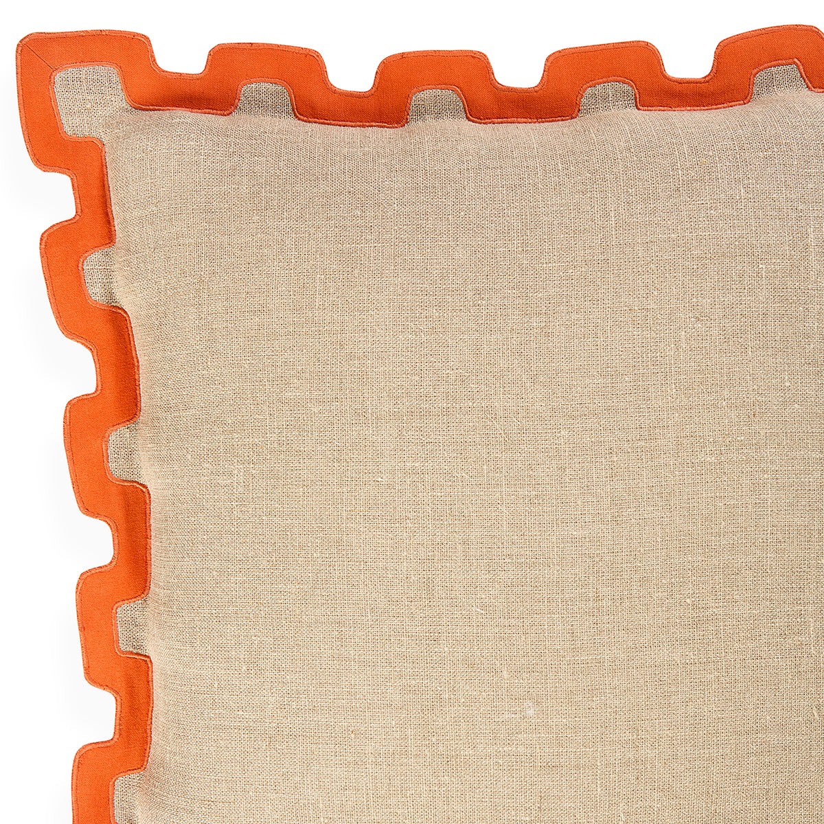 Close-up of a square beige woven cushion with a bright orange scalloped edge trim on a white background.