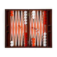An open wooden backgammon board set with orange playing field, white and red checkers, and dice, photographed from above on a white background.