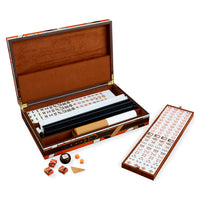 An open mahjong set displayed on a white background, showing the wooden case with brown interior, racks, tiles, dice, and a separate scoring board.