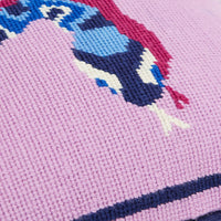 Close-up of a cross-stitched design on fabric with a pink background